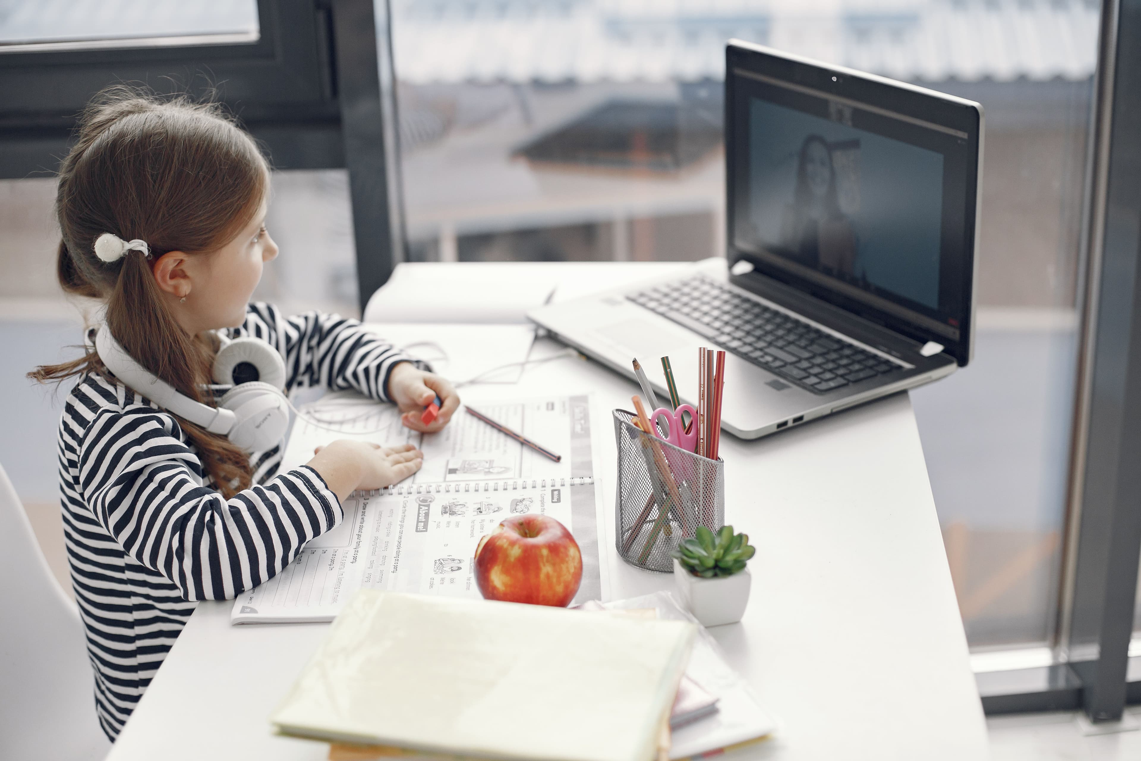 Family supporting child during online class
