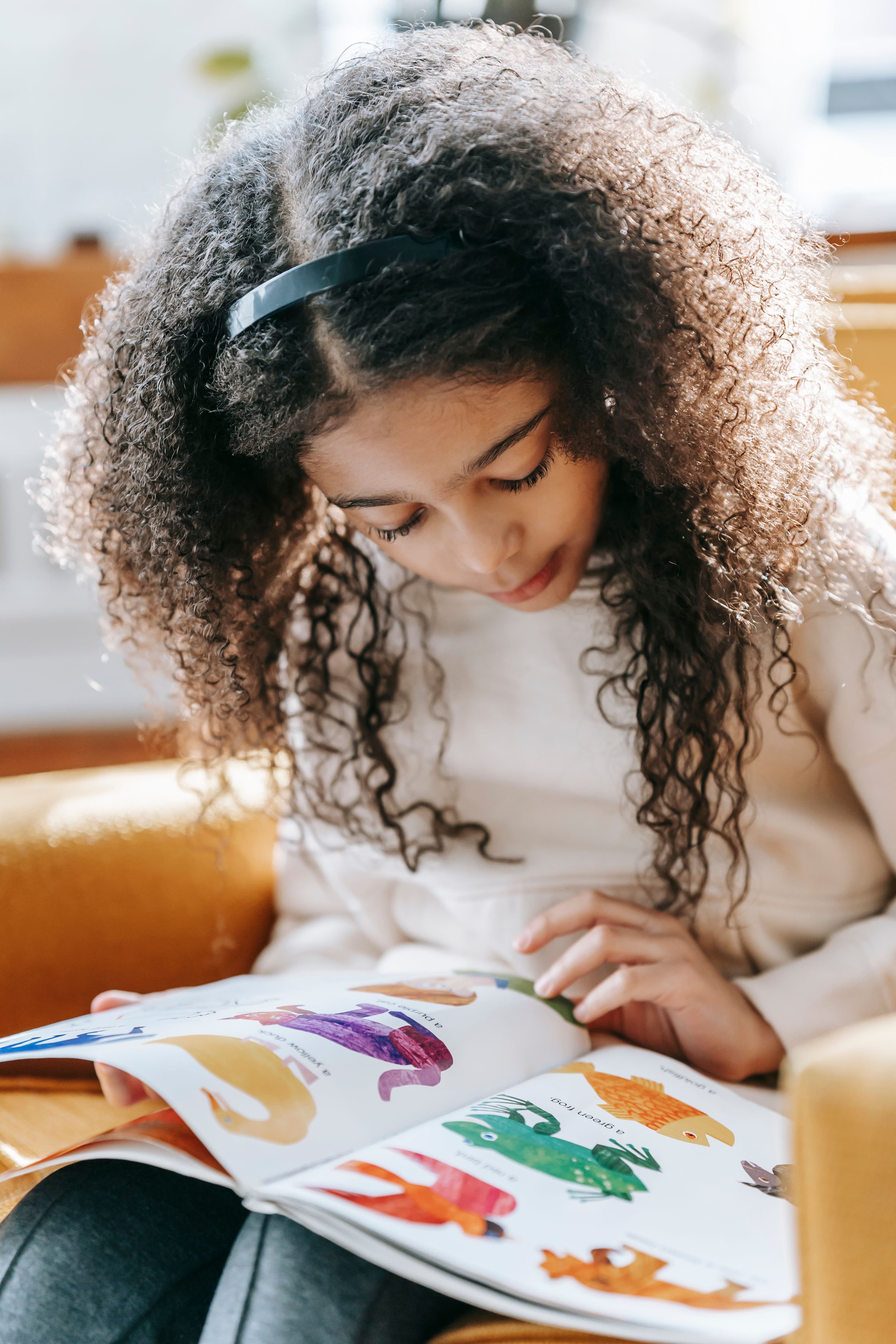 Young child reading a book attentively