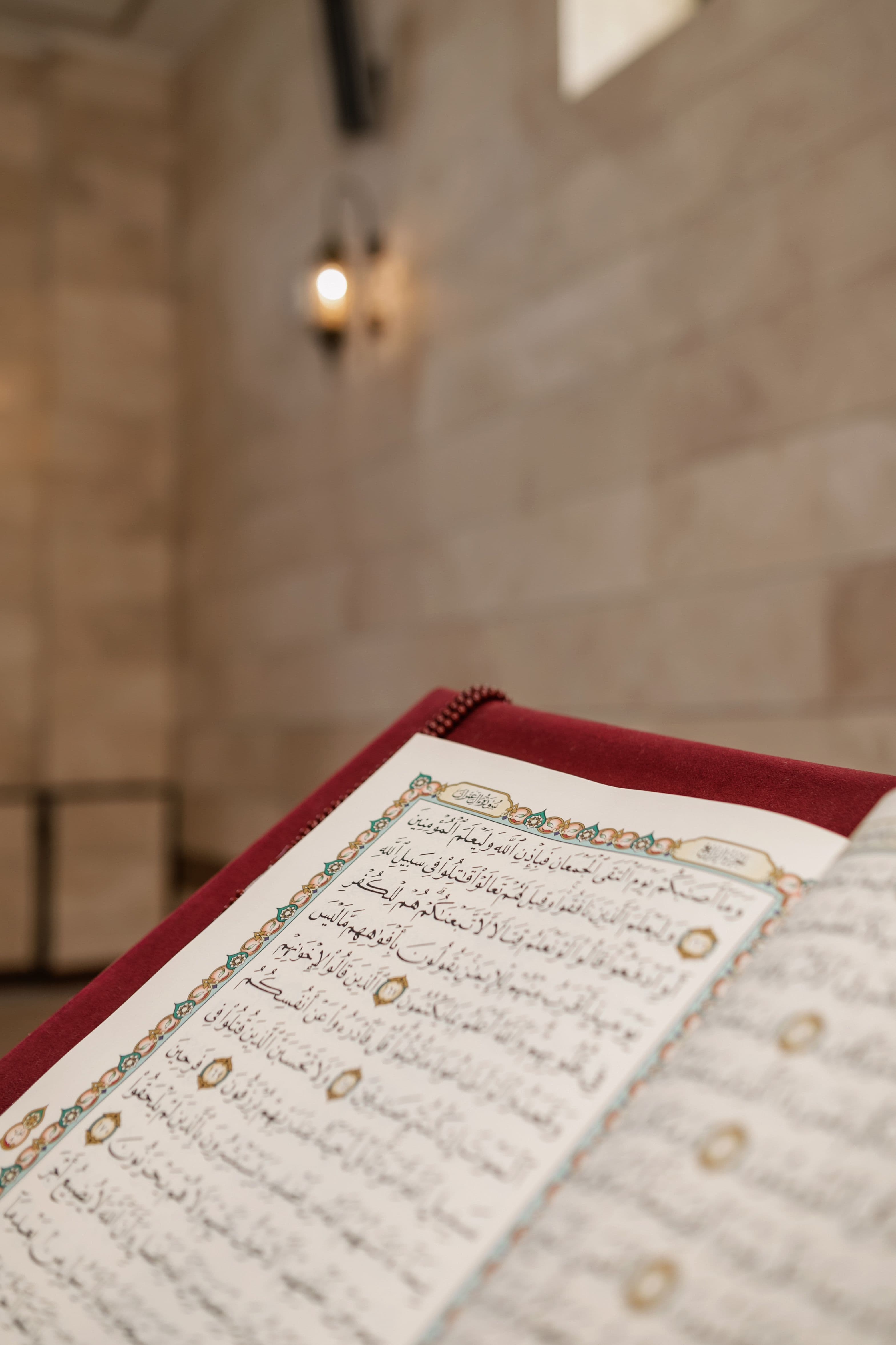 Quran with prayer beads beside it