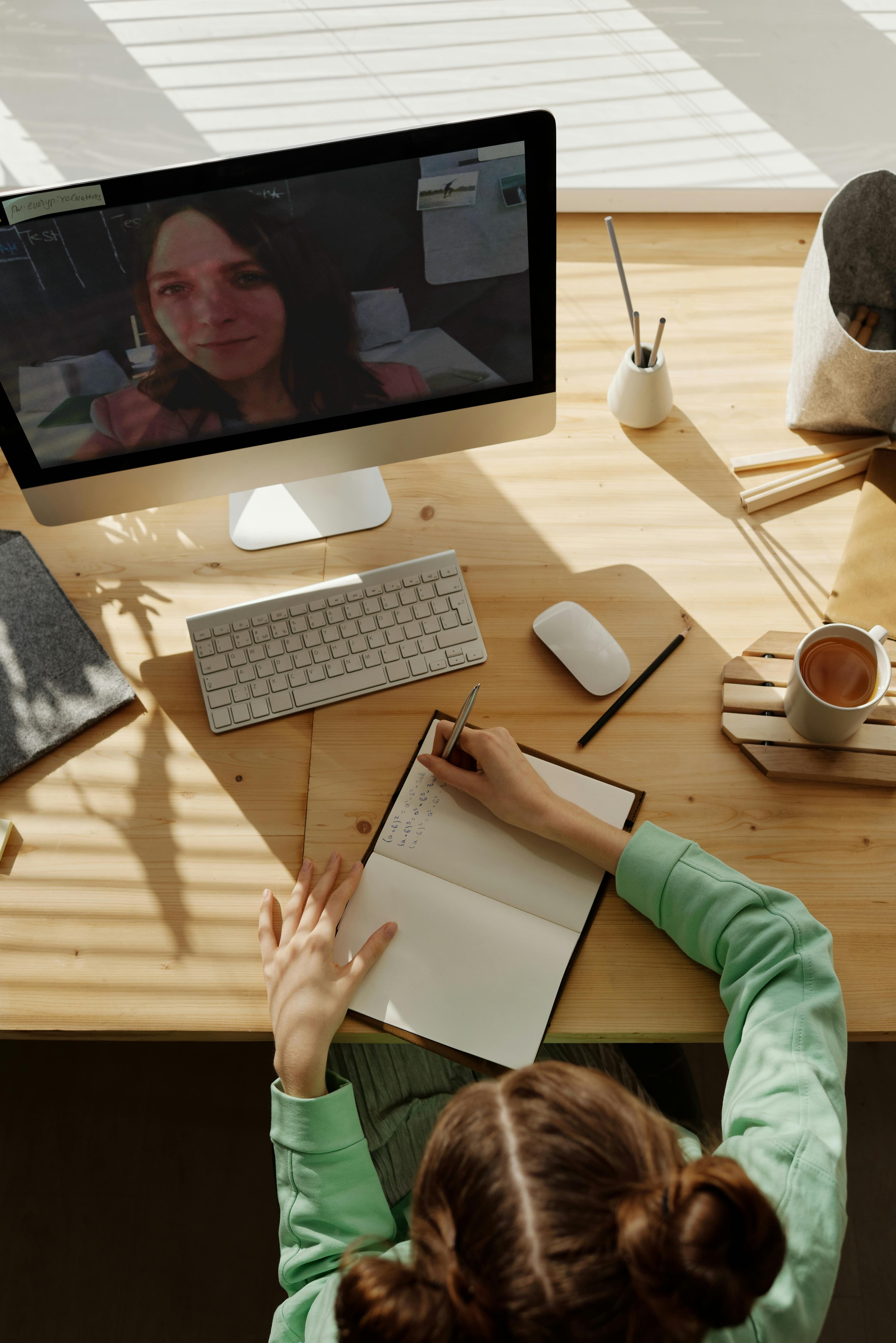 Open laptop with notebook for online study