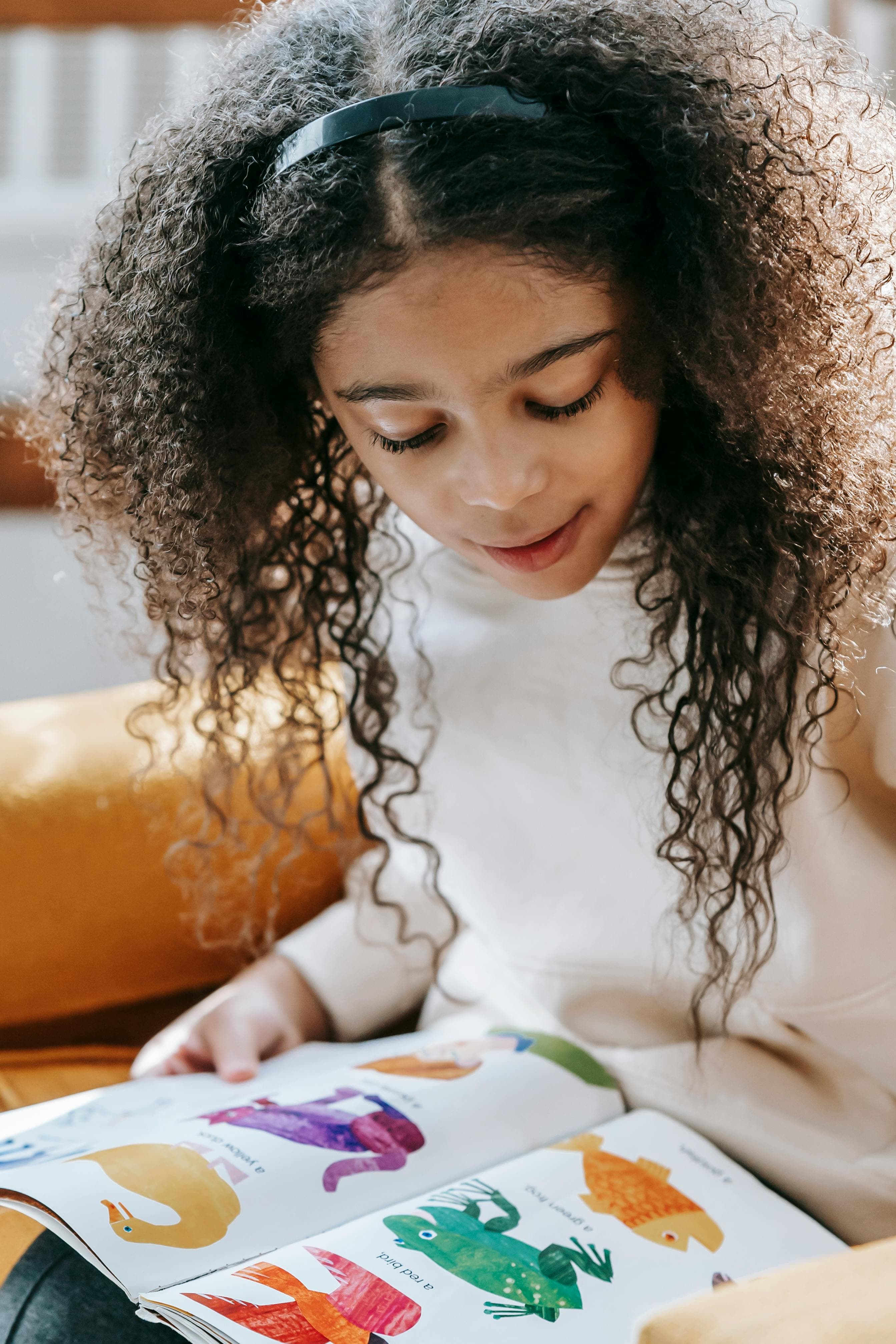 Child sitting and reading a book